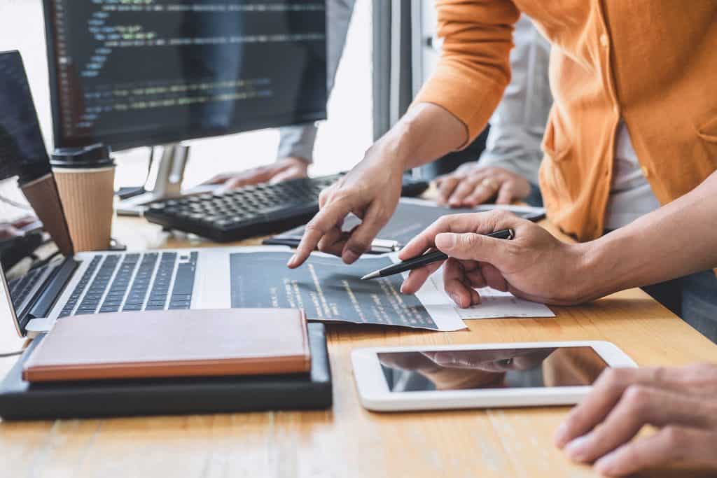 Team reviewing website and software development work